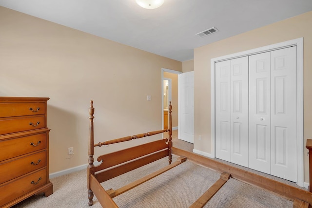 bedroom with light carpet and a closet