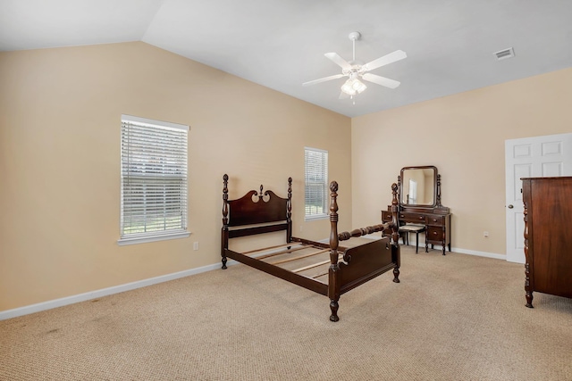 bedroom with ceiling fan, vaulted ceiling, and light carpet