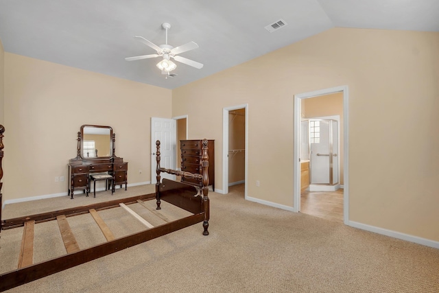 bedroom with vaulted ceiling, carpet flooring, a spacious closet, ceiling fan, and a closet