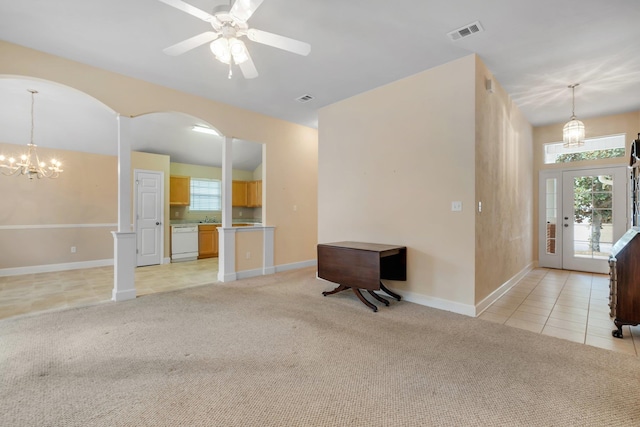 unfurnished living room featuring light colored carpet and ceiling fan with notable chandelier