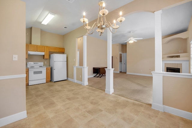 kitchen featuring lofted ceiling, a tiled fireplace, light colored carpet, light brown cabinets, and white appliances