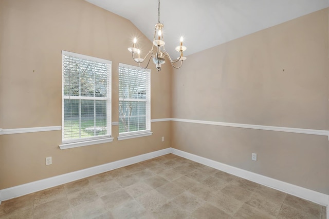 empty room with lofted ceiling and a chandelier