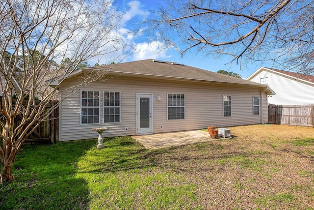 rear view of property with a yard and a patio area