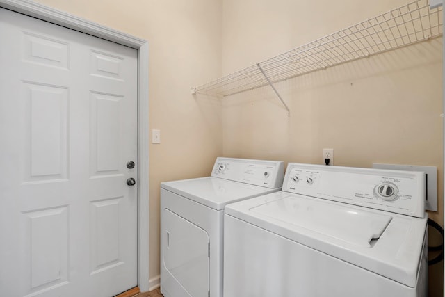 clothes washing area with separate washer and dryer