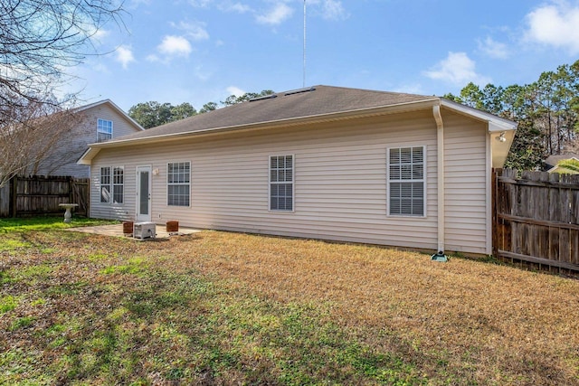 back of property with central AC unit, a yard, and a patio