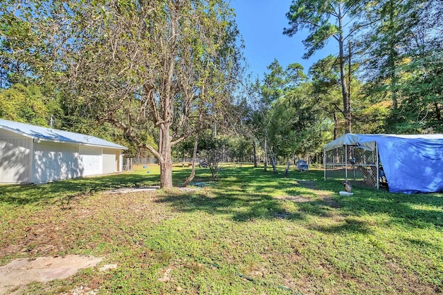 view of yard featuring a garage and an outdoor structure