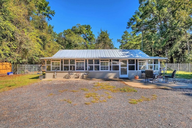 ranch-style house with a sunroom and a patio area