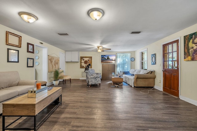 living room with ceiling fan and dark hardwood / wood-style flooring