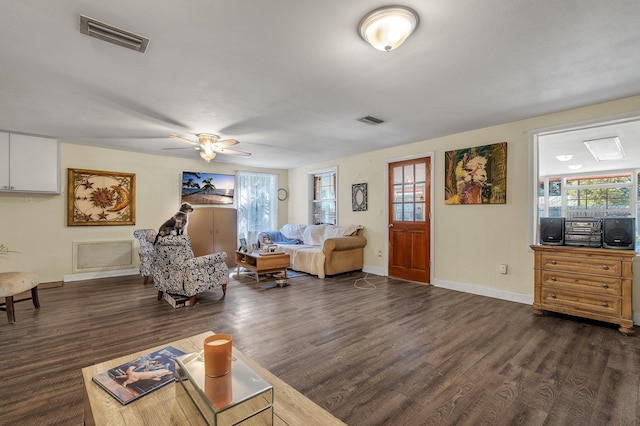 living room featuring ceiling fan, dark hardwood / wood-style floors, and a healthy amount of sunlight