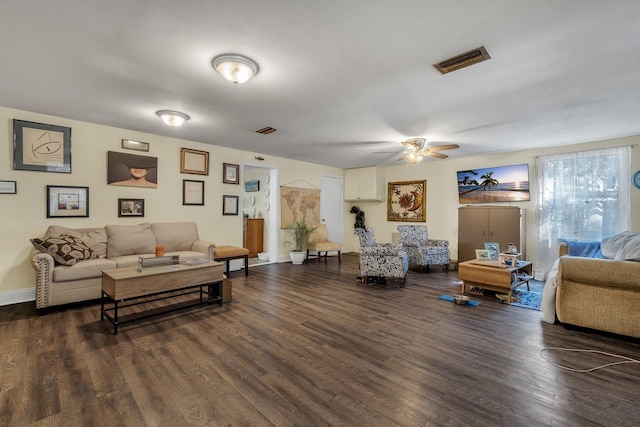 living room with dark wood-type flooring and ceiling fan