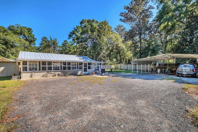 view of front of property featuring a sunroom and a carport