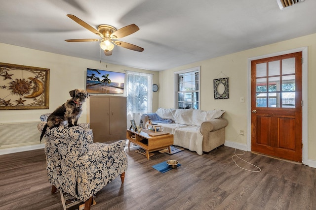 living room featuring dark hardwood / wood-style floors and ceiling fan