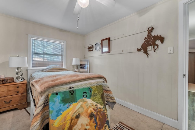 carpeted bedroom featuring ceiling fan and crown molding