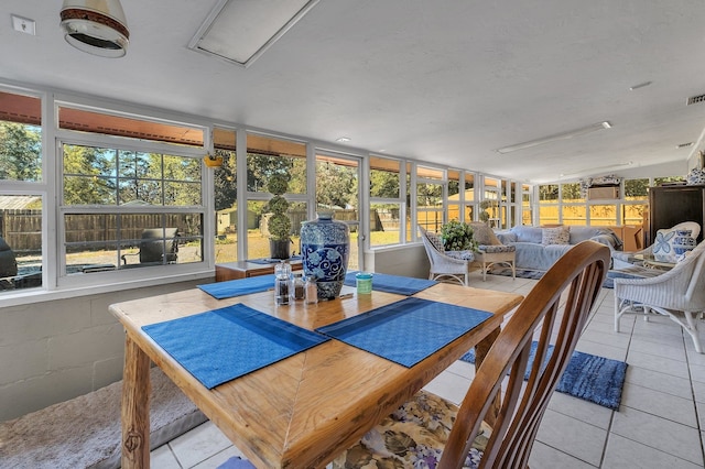 sunroom with a healthy amount of sunlight and lofted ceiling