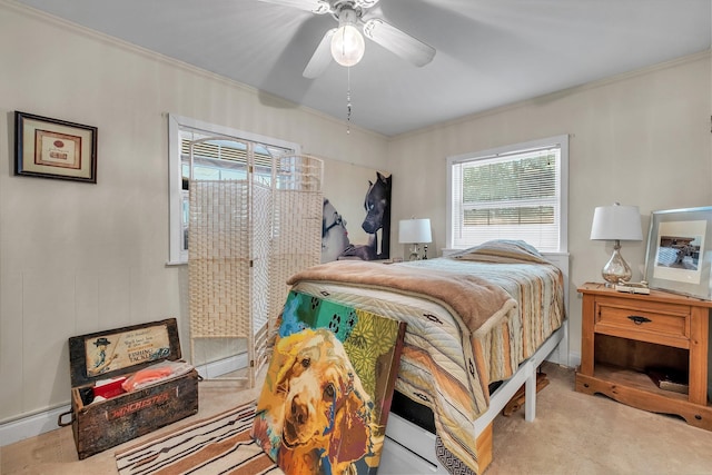 carpeted bedroom featuring ceiling fan and ornamental molding