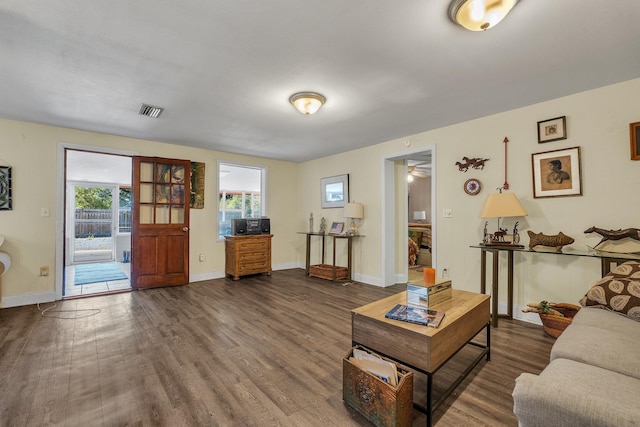 living room with ceiling fan and dark hardwood / wood-style floors