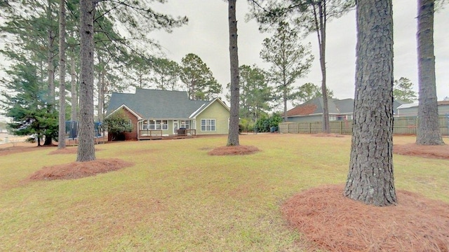 view of front of home featuring a deck and a front lawn