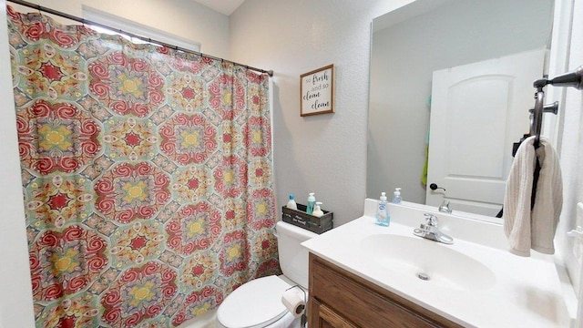 bathroom with vanity, toilet, and walk in shower