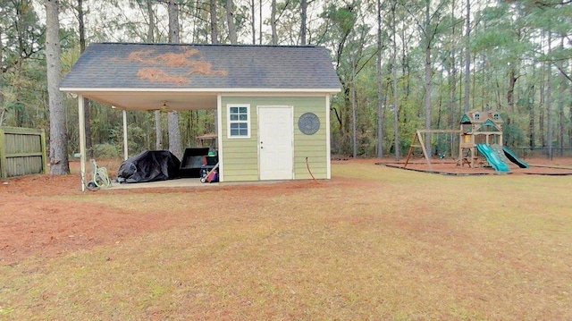 view of outbuilding featuring a yard and a playground