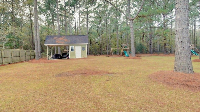 view of yard featuring a playground and a shed