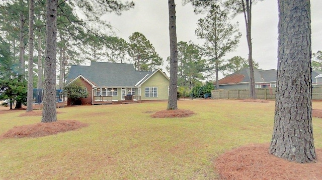 ranch-style house with a wooden deck and a front yard