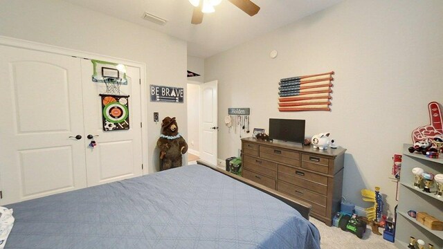 bedroom featuring carpet floors, ceiling fan, and a closet