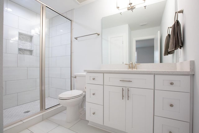 bathroom featuring a shower with door, vanity, toilet, and tile patterned flooring