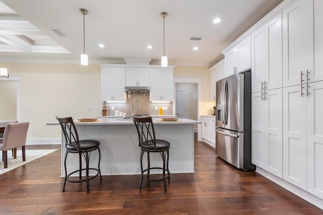 kitchen with white cabinets, hanging light fixtures, and stainless steel fridge with ice dispenser