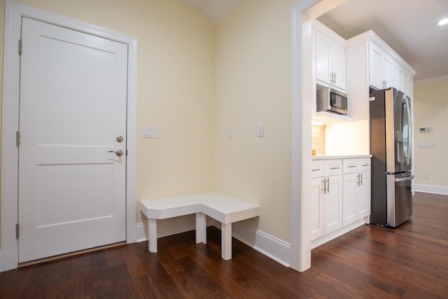 mudroom with dark hardwood / wood-style floors and crown molding