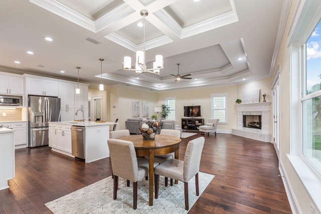 dining area with dark wood-type flooring and a healthy amount of sunlight