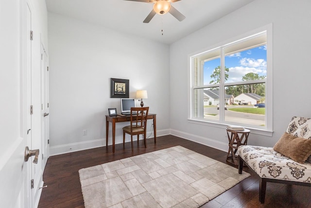 living area featuring ceiling fan and dark hardwood / wood-style floors