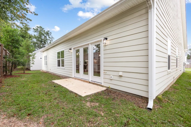 back of property featuring french doors and a yard