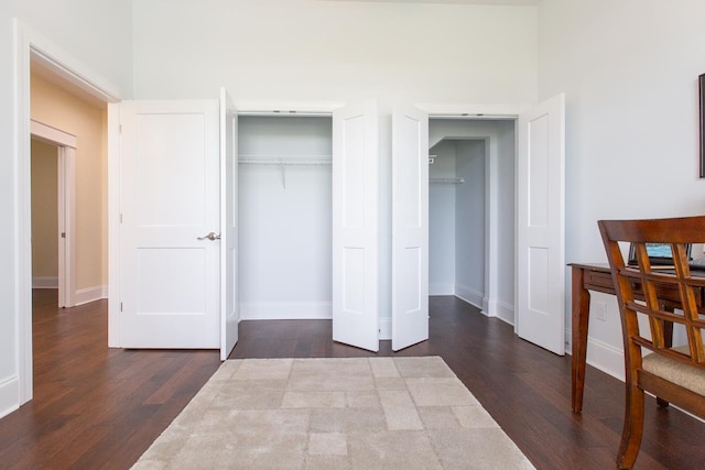 bedroom with dark hardwood / wood-style flooring