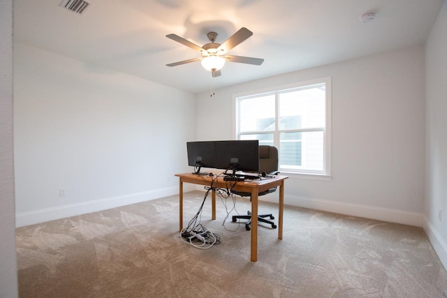 carpeted home office featuring ceiling fan