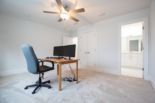 office with light carpet and ceiling fan