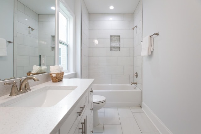 full bathroom featuring tile patterned floors, vanity, tiled shower / bath combo, and toilet