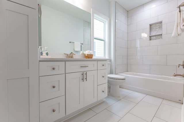 full bathroom featuring tile patterned floors, vanity, toilet, and tiled shower / bath combo