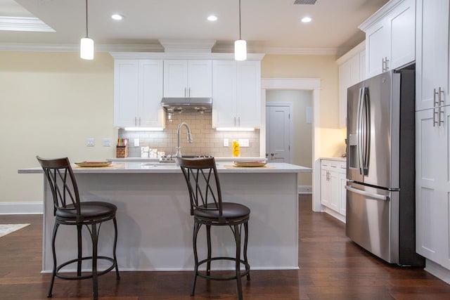 kitchen featuring stainless steel refrigerator with ice dispenser, decorative light fixtures, and white cabinets