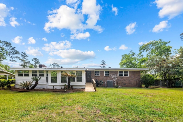 1106 Richardson Rd, Tallahassee, FL 32301 - rear view of house featuring fence, brick siding, a sunroom, cooling unit, and a yard