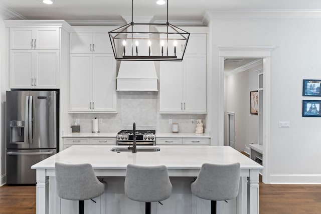 kitchen with white cabinets, an island with sink, stainless steel appliances, and custom exhaust hood