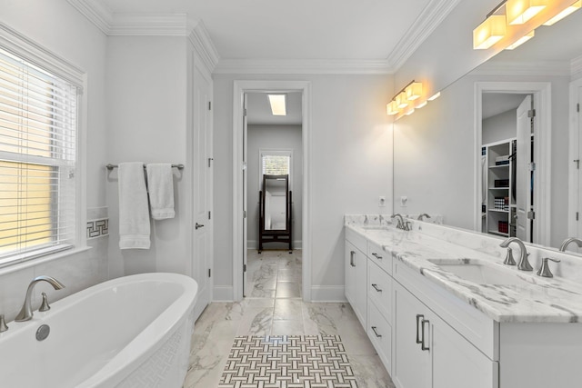 bathroom featuring ornamental molding, vanity, and a bathing tub