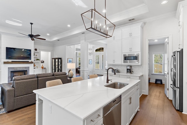 kitchen with white cabinetry, an island with sink, and appliances with stainless steel finishes