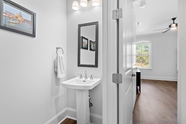 bathroom featuring hardwood / wood-style flooring, ceiling fan, and ornamental molding