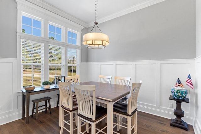 dining space with dark hardwood / wood-style floors and ornamental molding