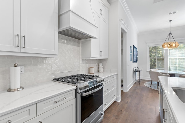 kitchen with white cabinets, custom exhaust hood, and stainless steel range with gas stovetop