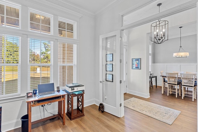 office space with wood-type flooring, ornamental molding, and a chandelier