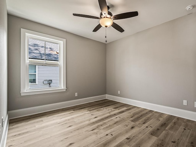 empty room featuring ceiling fan and light hardwood / wood-style flooring