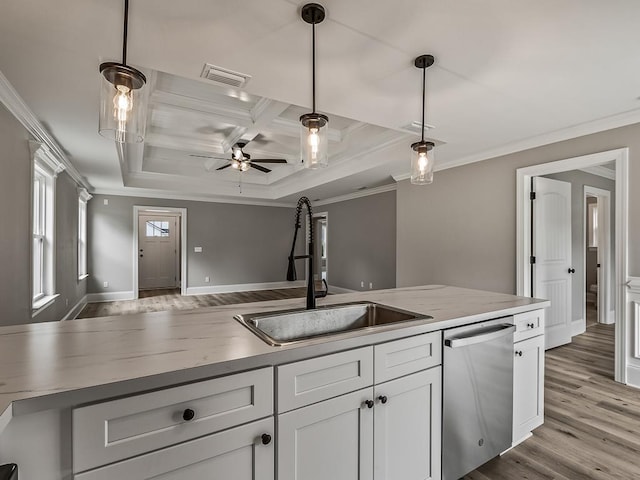 kitchen with pendant lighting, white cabinetry, dishwasher, and sink