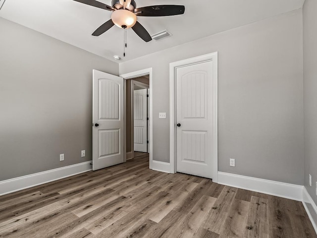 unfurnished bedroom with light hardwood / wood-style floors and ceiling fan