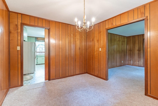 unfurnished room with wood walls and light carpet